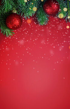 Red background with fir branches and Christmas ball. Christmas decoration.