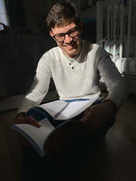 Portrait of happy young  man studying at home on self isolation