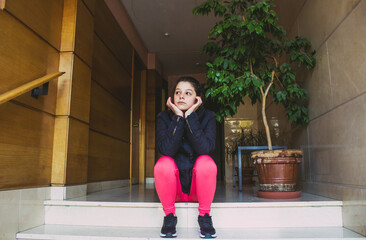 young woman waiting in a building portal