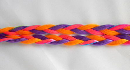 Colored artificial strands of hair. Bright multicolored braids on a white background. Beautiful abstract background.Material for weaving