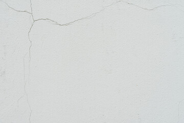 Concrete wall with cracks, texture of ruined plaster, light gray color. Background