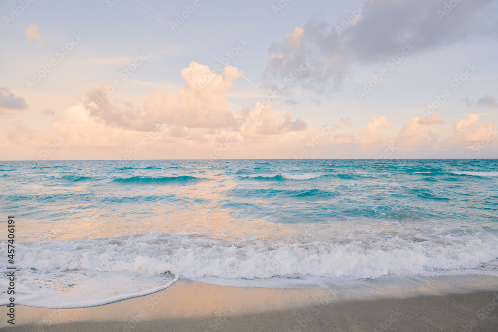 Wall mural blue ocean with foam at sunset. airy light tranquil water landscape.