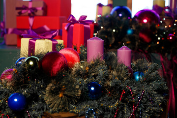 Colorful boxes with gifts near the Christmas tree.