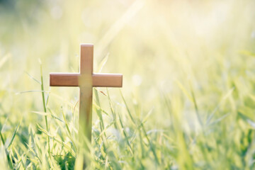 Cross on blurry sunset background.