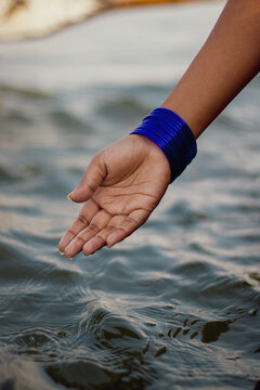 Close up photo of person touching water surface