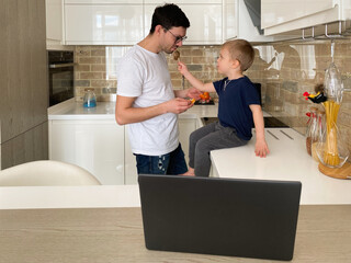 Boy feeding his father in breakfast