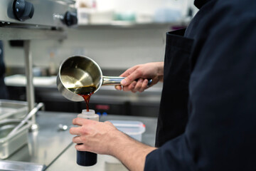 chef preparing sauce for his dishes