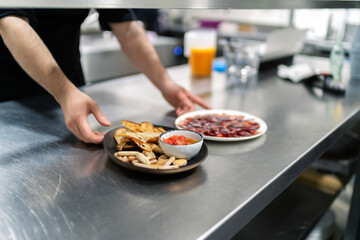 cook serving a plate of freshly cut ham