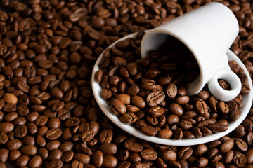 Cup and coffee bean at the black background