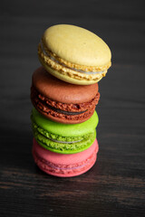 Multi-colored macarons in the black background