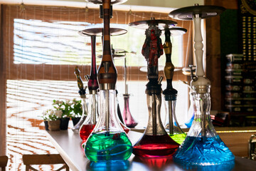 a hookah bar, some colorful smoking devices, ready to use, leisure vacation lounge