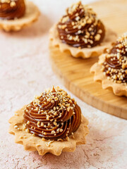 homemade desserts with caramel, nuts on a light background