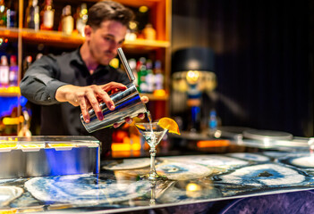 waiter serving a delicious cocktail at his place
