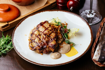 grilled steak with vegetables, sauce, herbs.