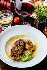 grilled steak with vegetables, sauce, herbs.