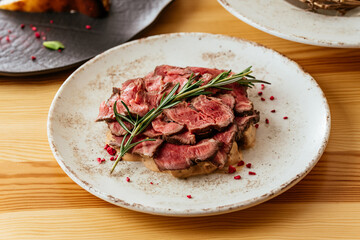 grilled steak with vegetables, sauce, herbs.