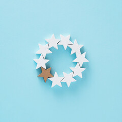 Creative Christmas arrangement made of wooden stars on a blue backgorund. Minimal .New Year concept.