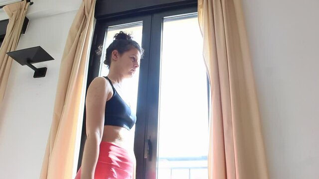 woman doing arm exercise at home with dumbbells