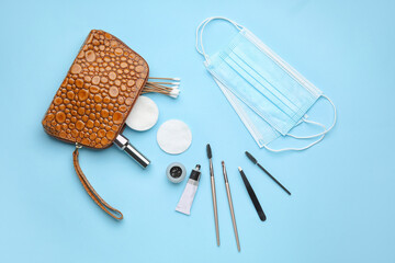 Cosmetic bag, henna and tools for eyebrows correction on color background