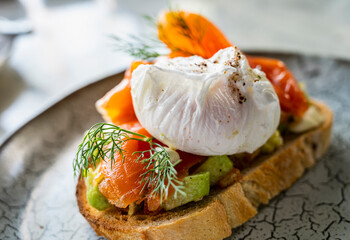 Salmon bruschetta with avocado and poached egg
