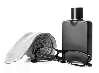 Stylish necktie, perfume and eyeglasses on white background