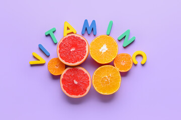 Text VITAMIN C and citrus fruits on color background