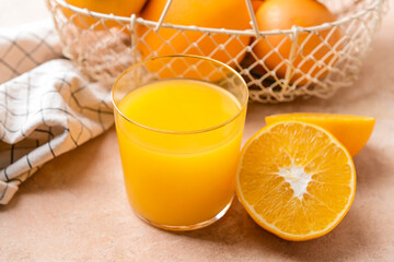 Glass with tasty orange juice on color background
