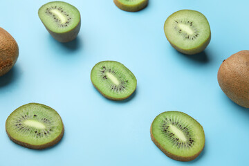 Fresh kiwi fruit with pieces on color background