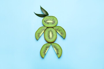 Human figure made of fresh kiwi fruit on color background