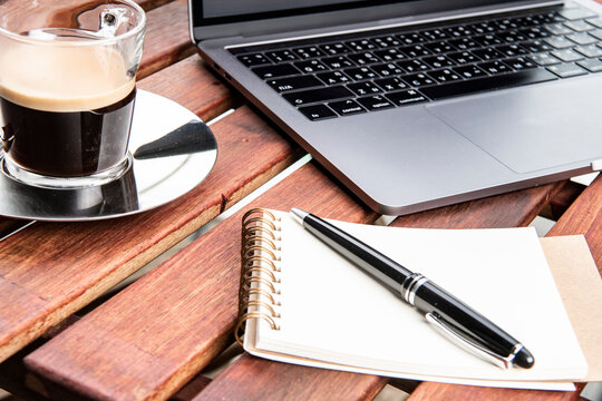laptop, coffee and notepad for remote working in Bangkok