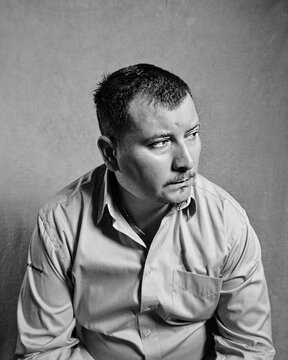 black and white portrait of man looking away