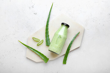 Bottle of healthy aloe juice on white background