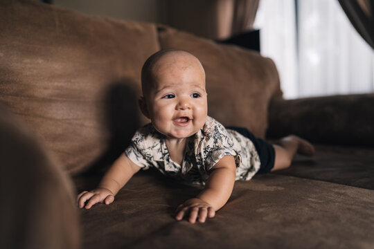 Cute Baby playing On Couch smiling