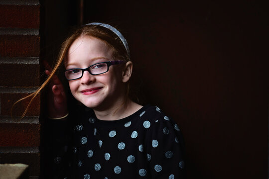 Cute Tween Girl With Red Hair Giggling And Smiling.