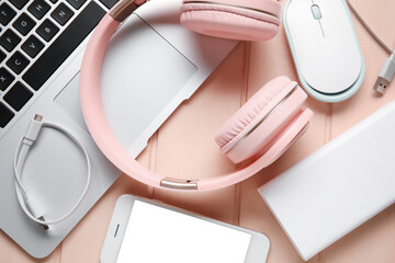 Different modern devices on color wooden background, closeup