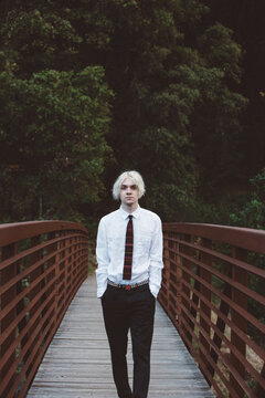 Portrait of Gen Z Teen on a Rust Colored Bridge Hands in Pockets