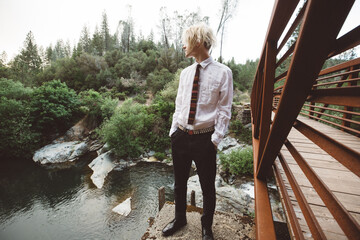 Portrait of Gen Z Teen on a Rust Colored Bridge Hands in Pockets