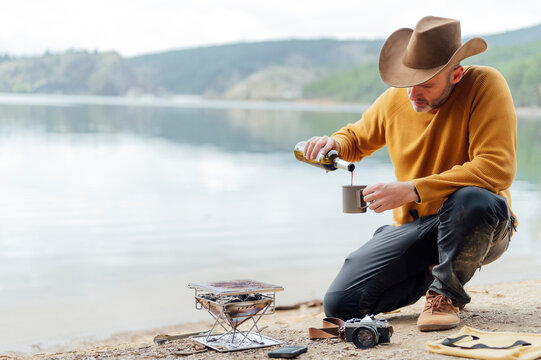 Man preparing barbecue on brazier in nature