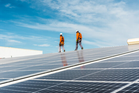 Unrecognizable solar panel technicians cheking a Spanish installation