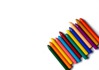 Multicolored crayons in a row and isolated on white.