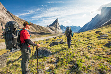 Backpackers hiking in Akshayak Pass, Canada.