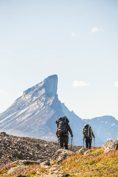 Two backpackers hike below Mt. Thor, Canada.