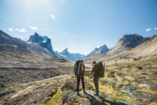 Two backpackers look at the route ahead, Akshayak Pass, Baffin Island.
