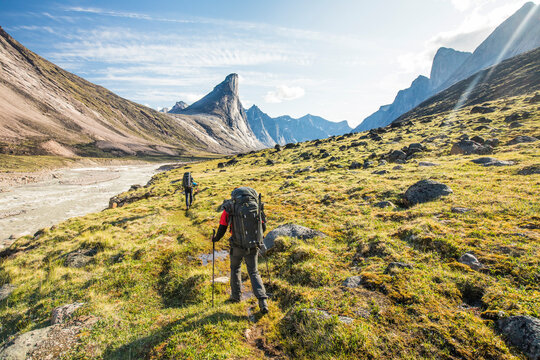 Climbers approach Mount Thor, Baffin Island, Canada.