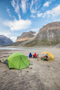 Rear view of climbers resting at basecamp after a long day of climbing