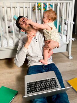 Man playing with his daughter wile working at home on selfisolation
