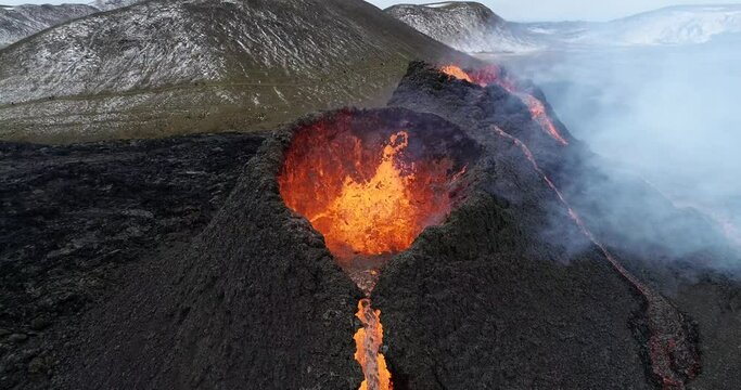 Lava flowing from active volcano from aerial view in 4k Dlog