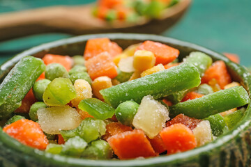 Bowl with different frozen vegetables, closeup