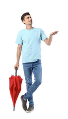 Displeased young man with umbrella on white background