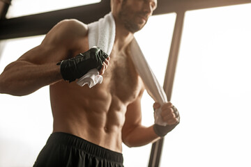 Sweaty male athlete with bandages on arm